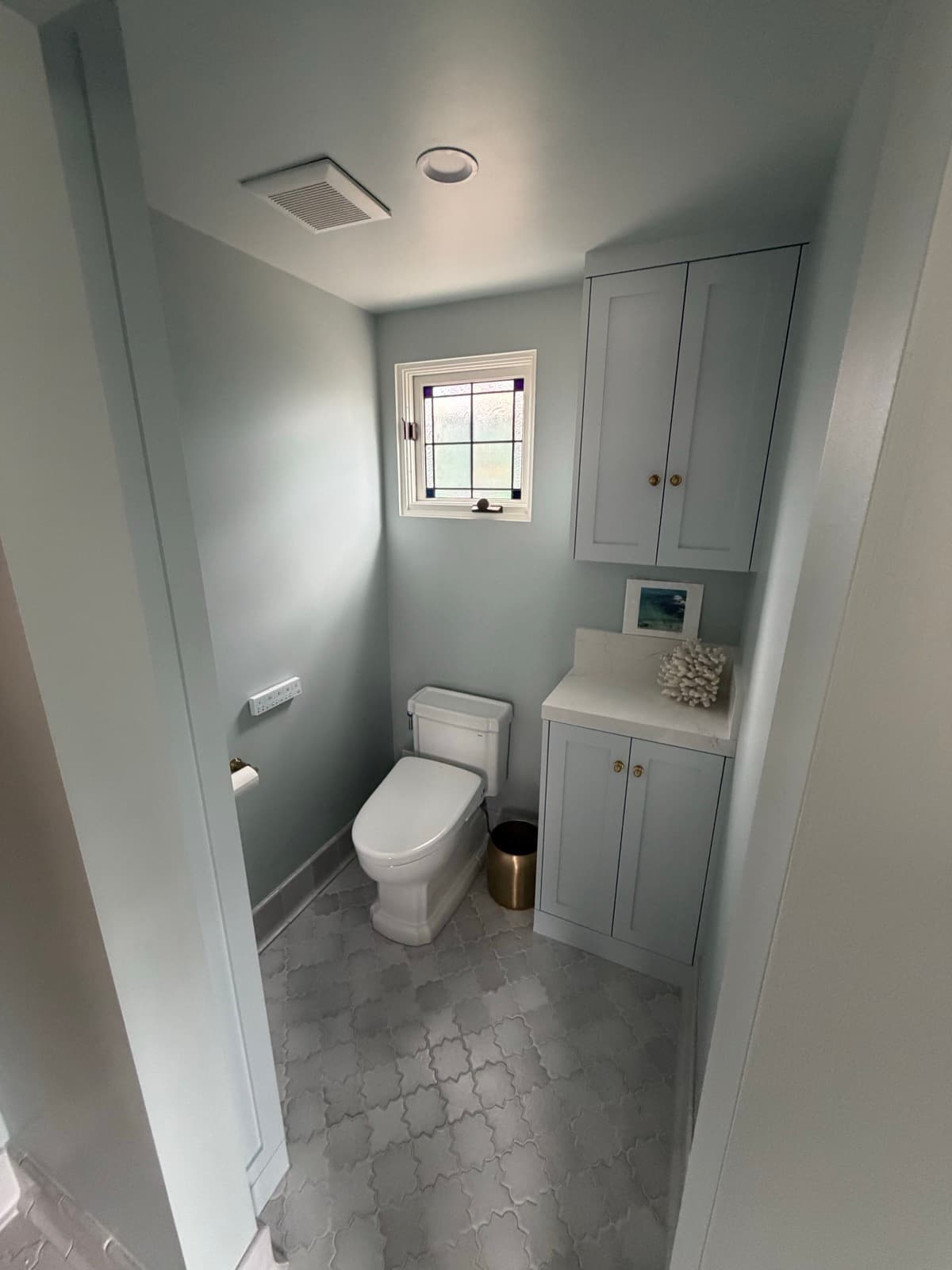 Coastal Blue Bath with a Stained-Glass Window