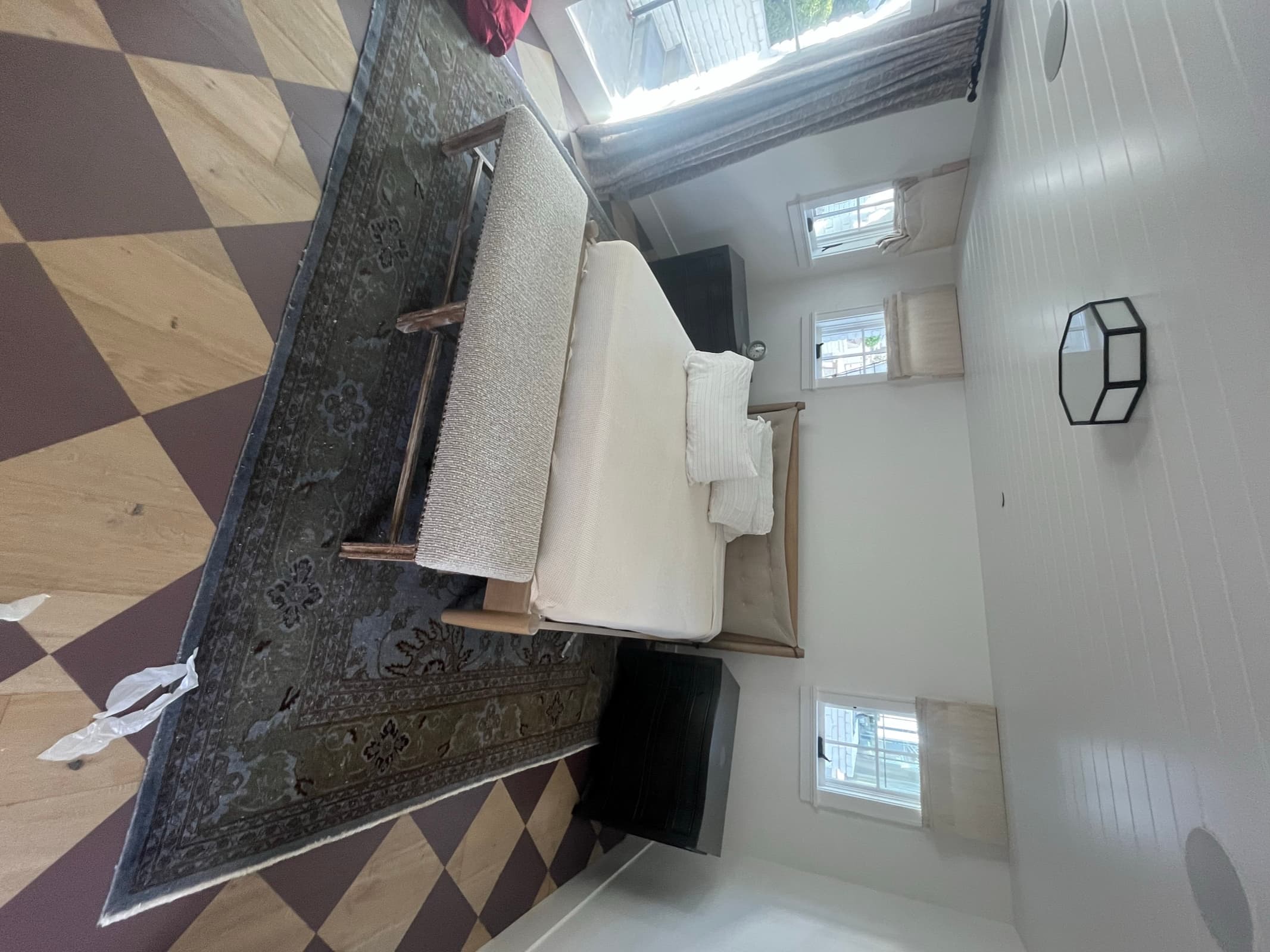 Before: bedroom with painted diamond-checkerboard plywood floor
