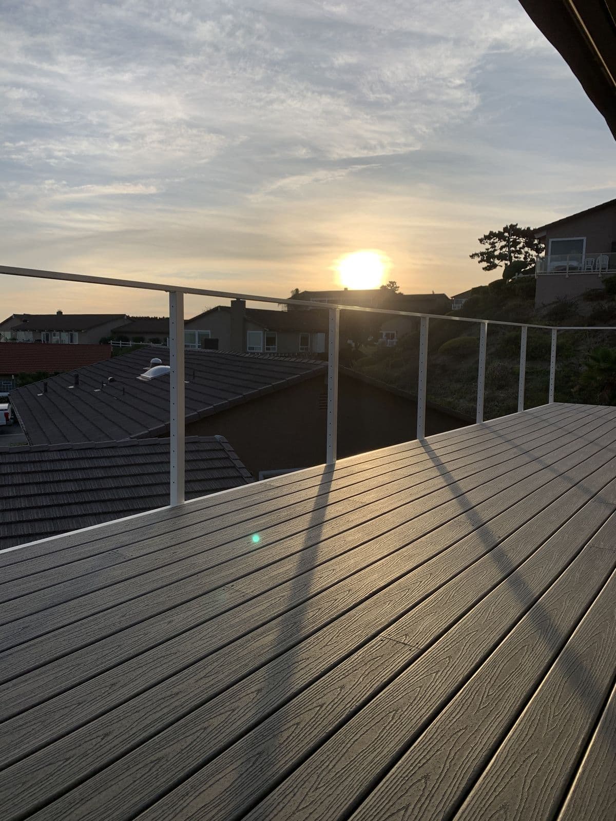 Cable railing detail with rooftops and sunset beyond