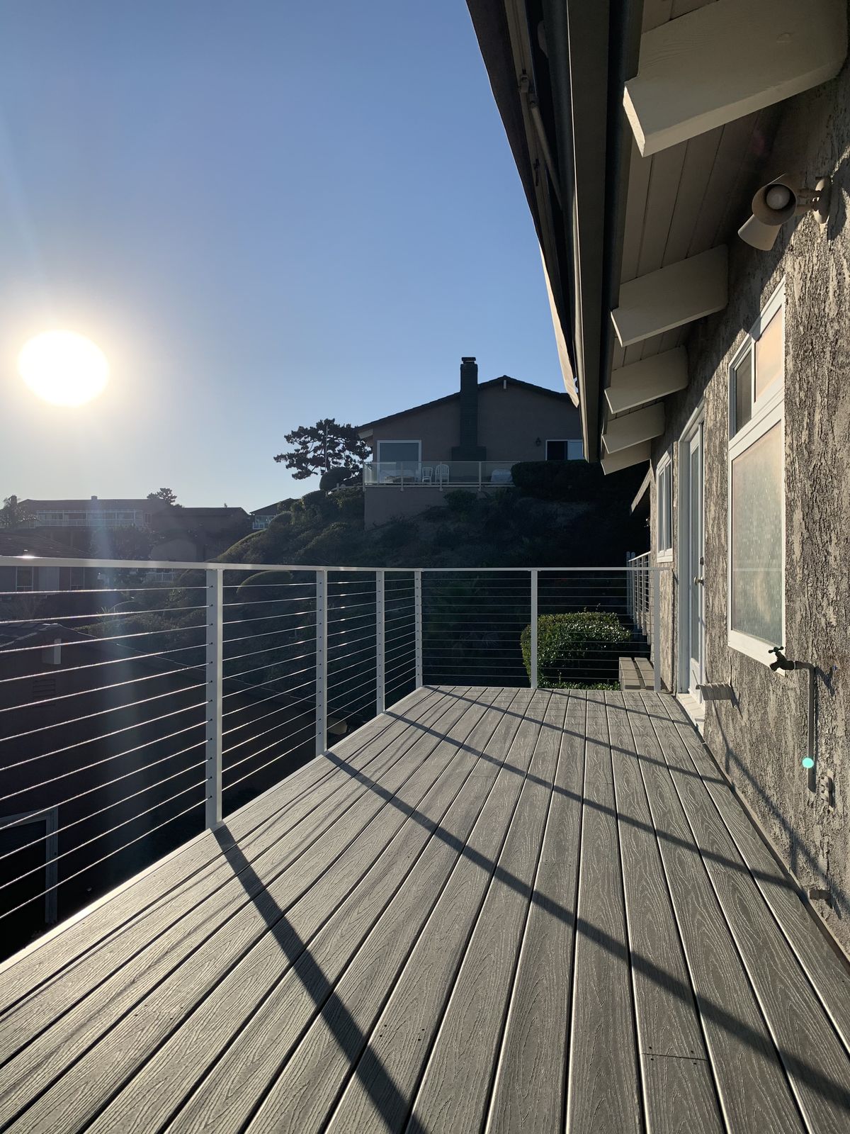 Deck surface and cable railing in low evening sun